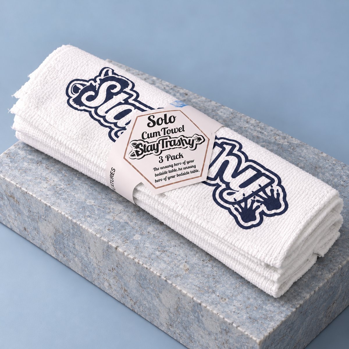 White Solo towel three-pack with dark navy Stay Trashy graphics and paper band